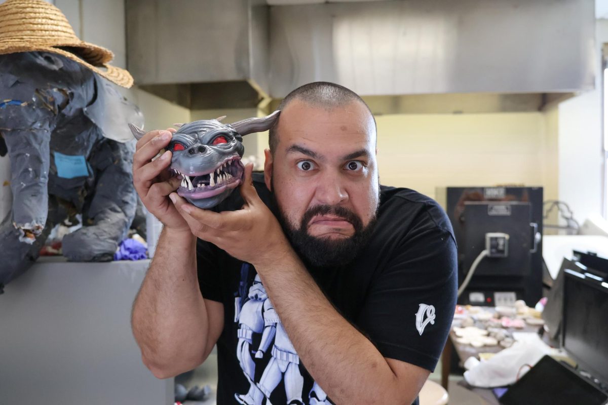 Mr. Montalvo at work in his art room with a Ghostbusters sculpture.