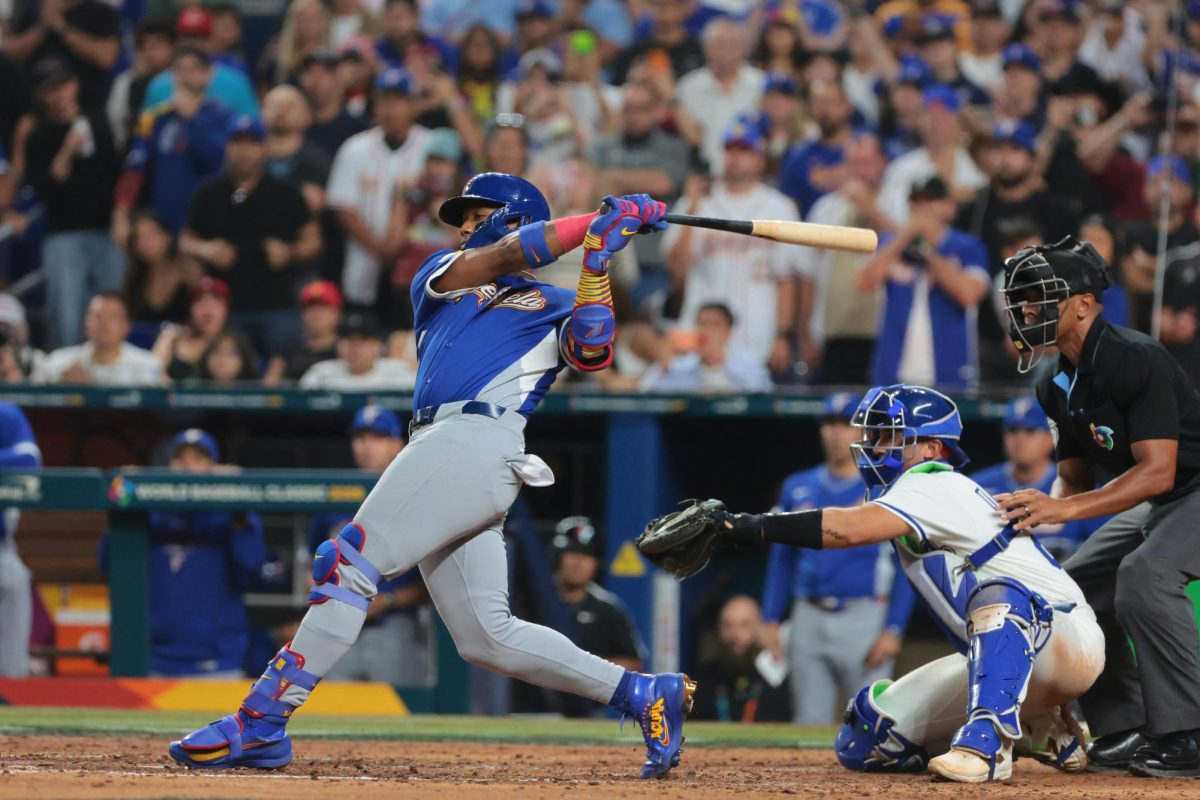 Mar 16, 2026; Miami, FL, United States; Venezuela outfielder Ronald Acuña Jr. (21) hits an RBI single in the seventh inning against Italy during a semifinal game of the 2026 World Baseball Classic at loanDepot Park. Mandatory Credit: Sam Navarro-Imagn Images